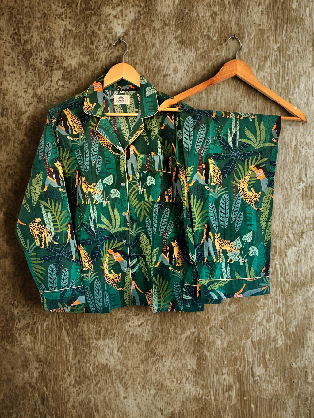 Jungle Escape Cotton PJ Set – shirt and trousers on hangers against textured wall