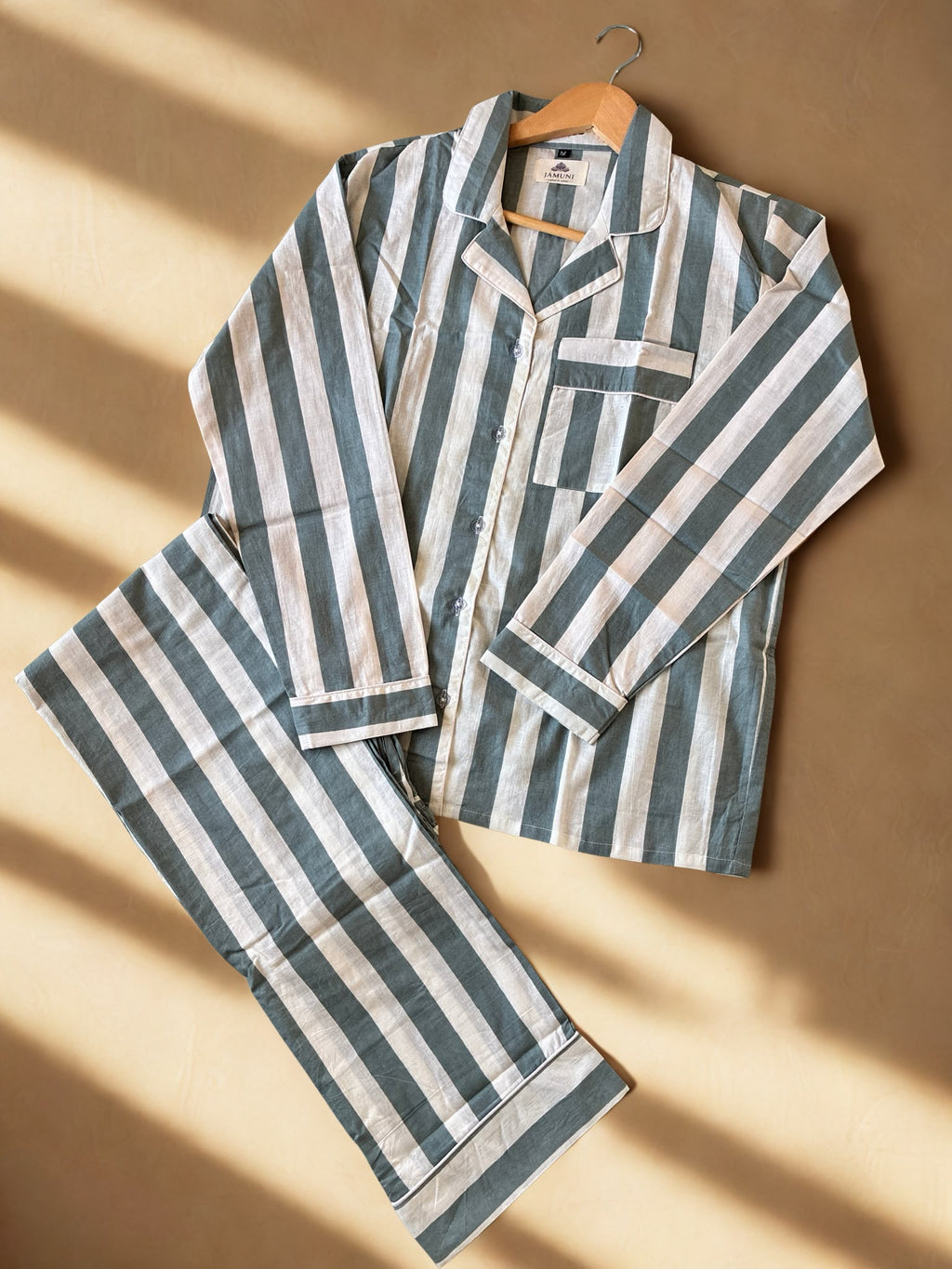 Sage Stripe Cotton PJ Set - flat lay on warm surface