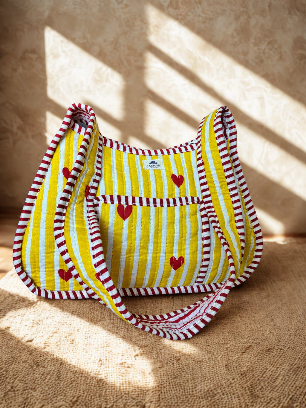 Heart Stripe Quilted Cotton Shoulder Bag - front view on surface