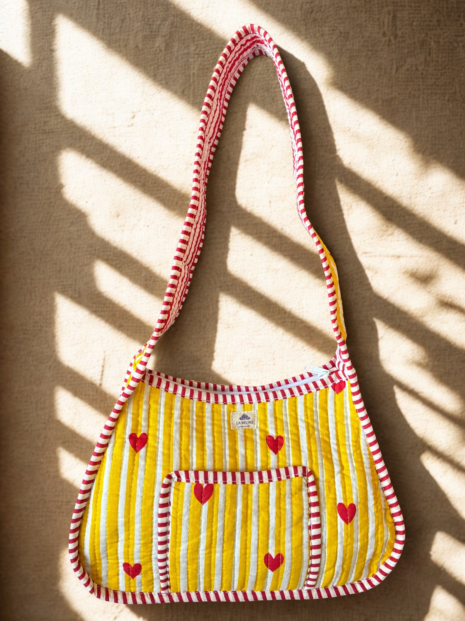 Heart Stripe Quilted Cotton Shoulder Bag - hanging on wall showing strap